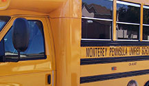 School Buses Parked near the Monterey Aquarium Means loads of kids on a field trip