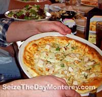 One Pizza per Person at the Monterey Restaurant, but they're personal Pizzas and quite filling. The Chicken Garlic is my Personal Favorite!